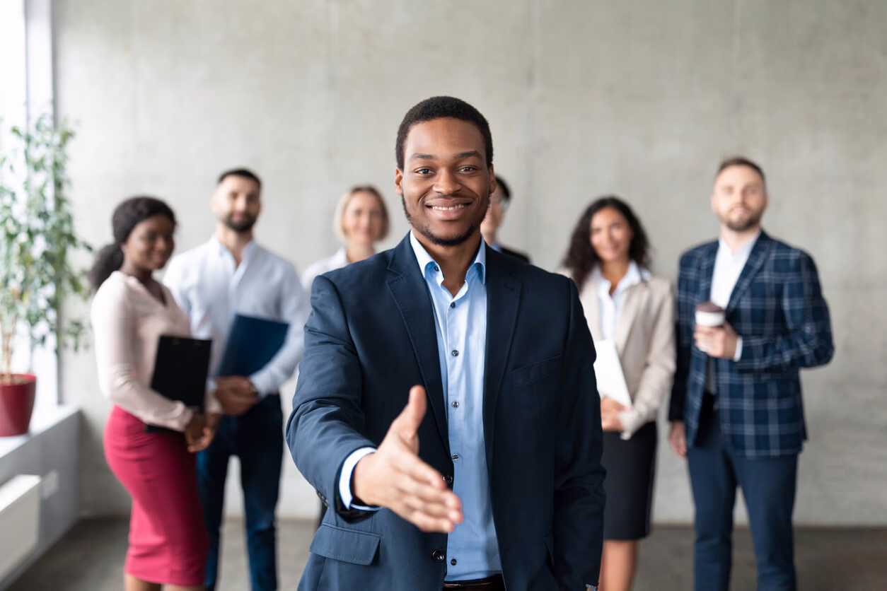 Businessman Stretching Hand For Handshake In Office